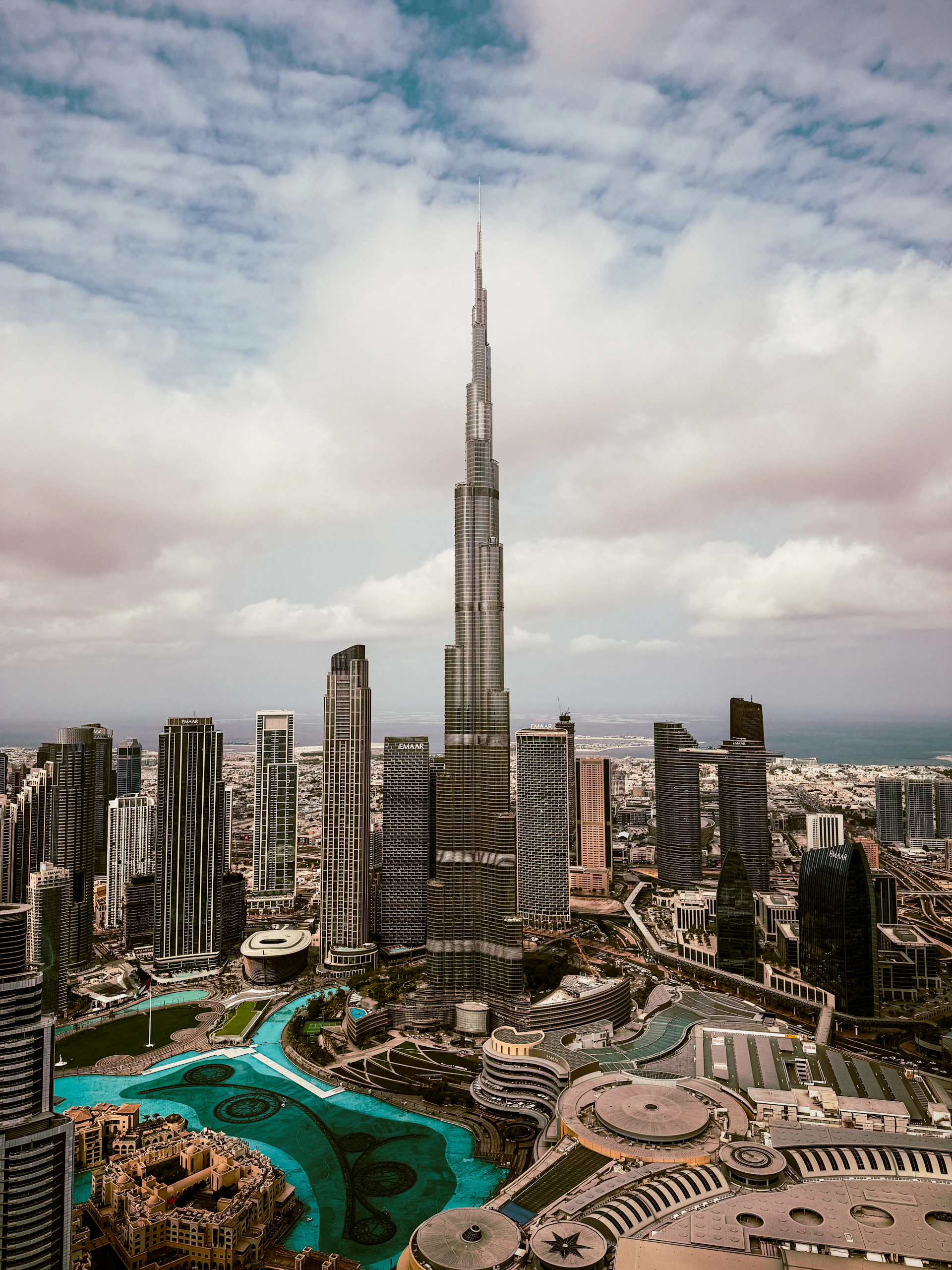 The burj khalifa stands tall amidst a city skyline.
