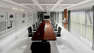 Modern, minimalist boardroom with long table and chairs.