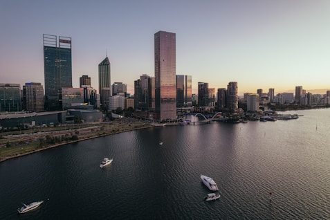 A city skyline with water and boats.