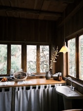 A rustic kitchen with a window view.
