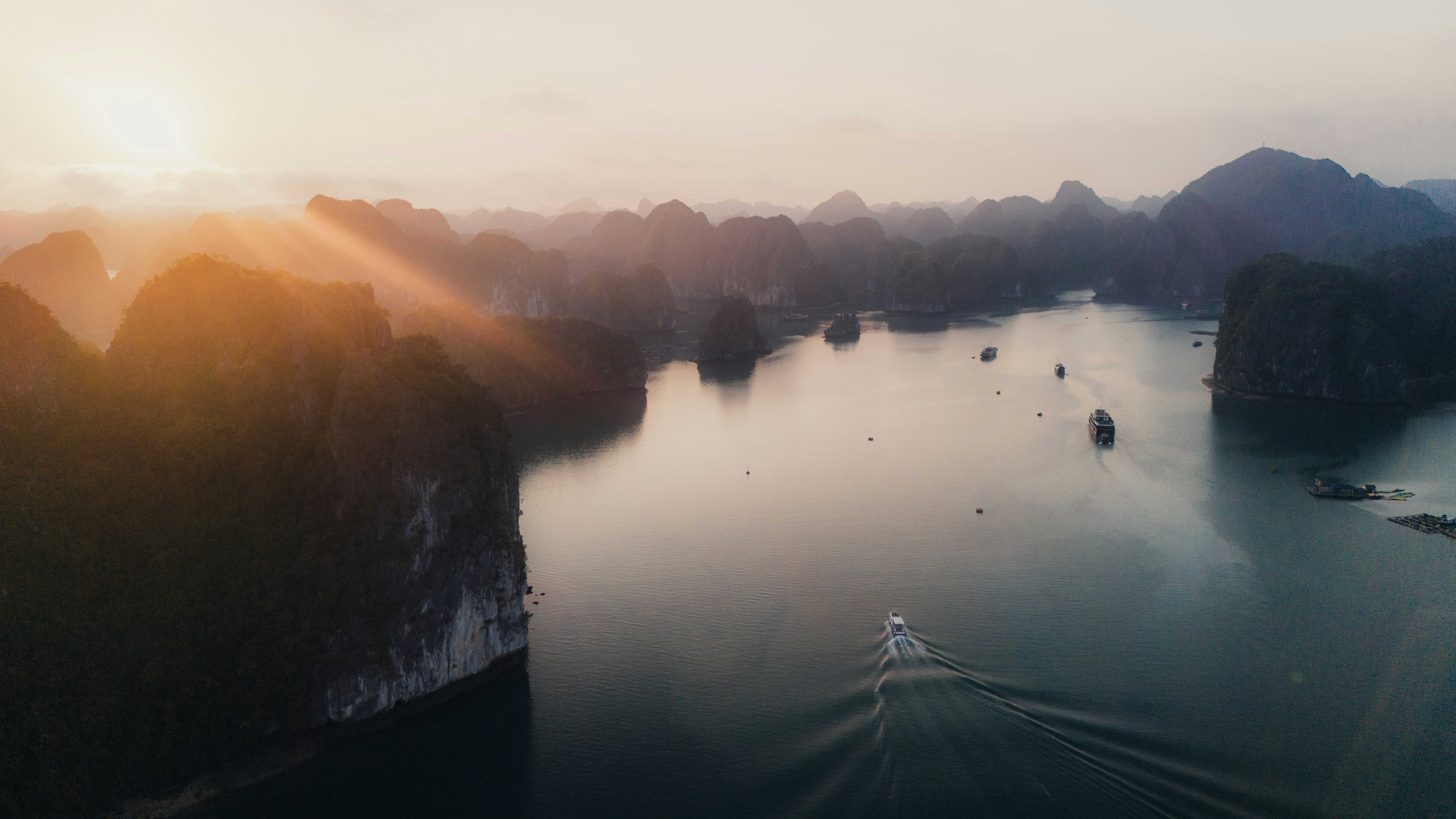 Sunrise over a tranquil bay with mountains.