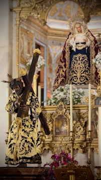 Statues of jesus carrying cross and virgin mary.