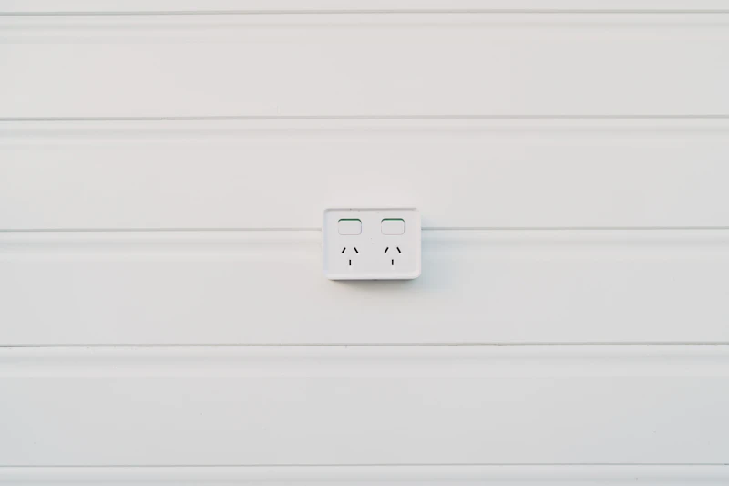 White Australian double power point installed on weatherboard wall