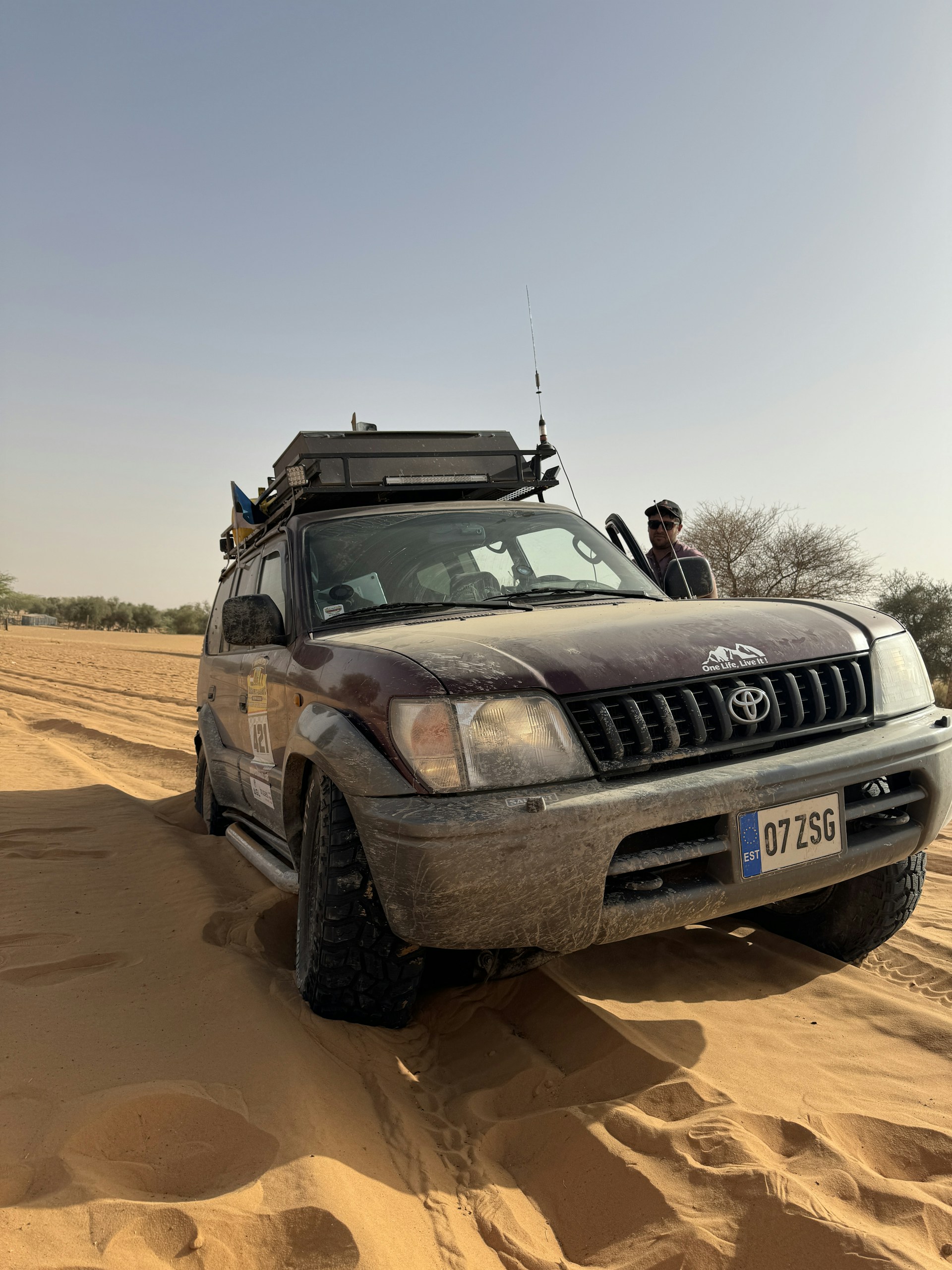 A 4x4 travels through the desert sands.