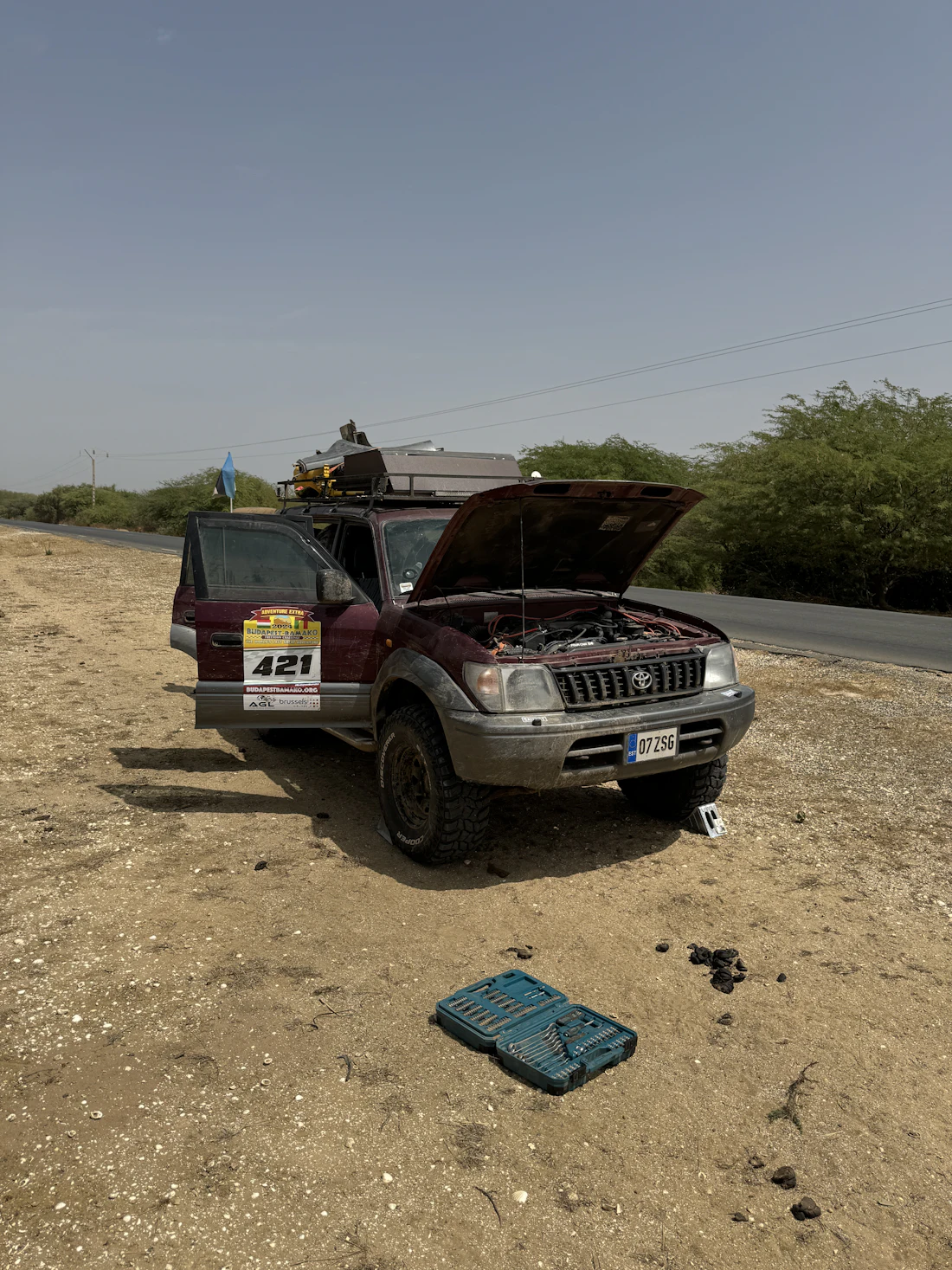 A car broken down at the side of the road