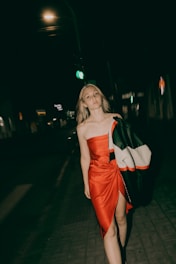 A woman poses in the night.