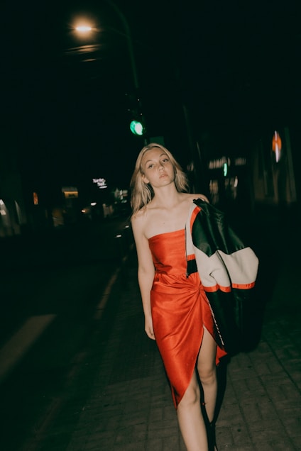 A woman poses in the night.