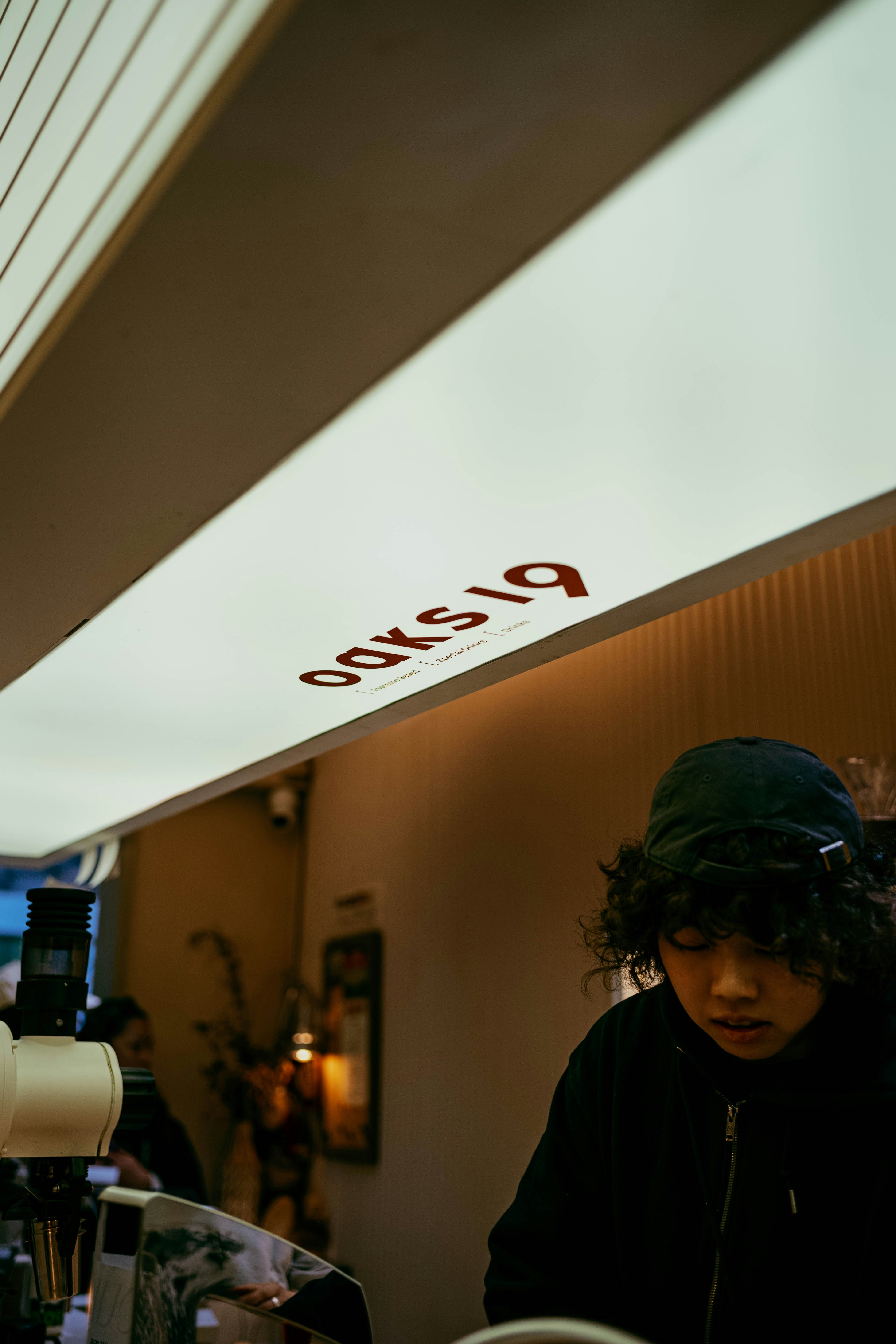 A person works behind a cafe counter.