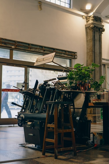 An old printing press is shown in the room.