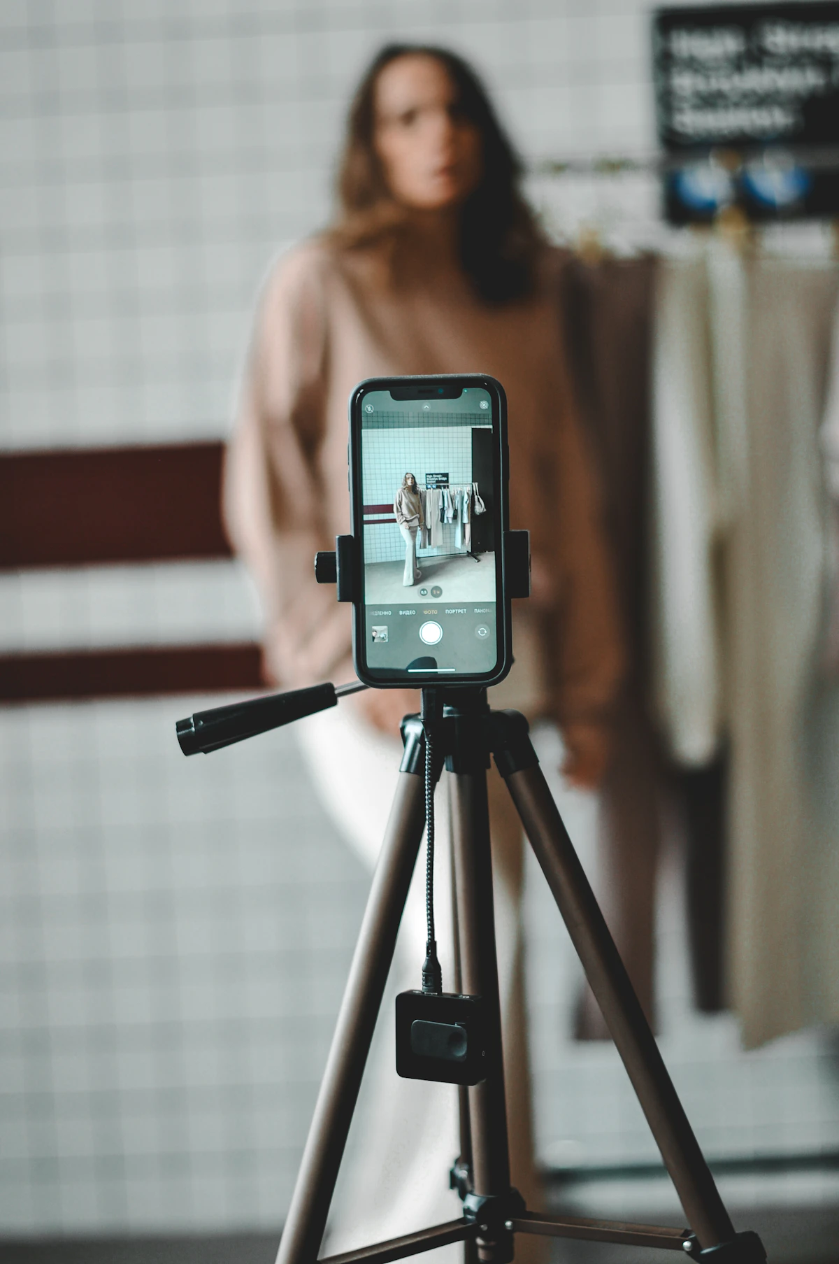 Creator filming a product video with a smartphone on a tripod