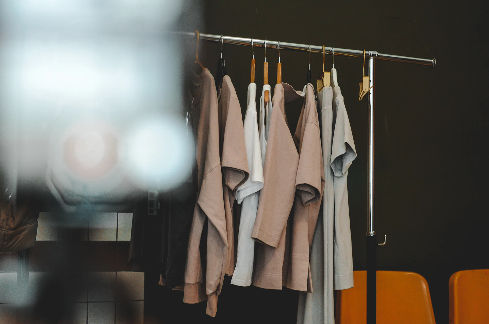 A minimalist clothes rack with neutral garments, suggesting a thoughtful activism apparel gift
