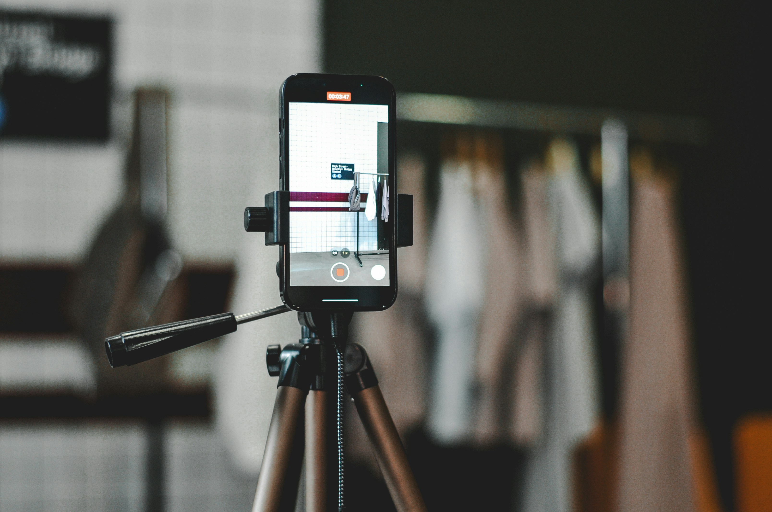 A phone is recording content on a tripod.