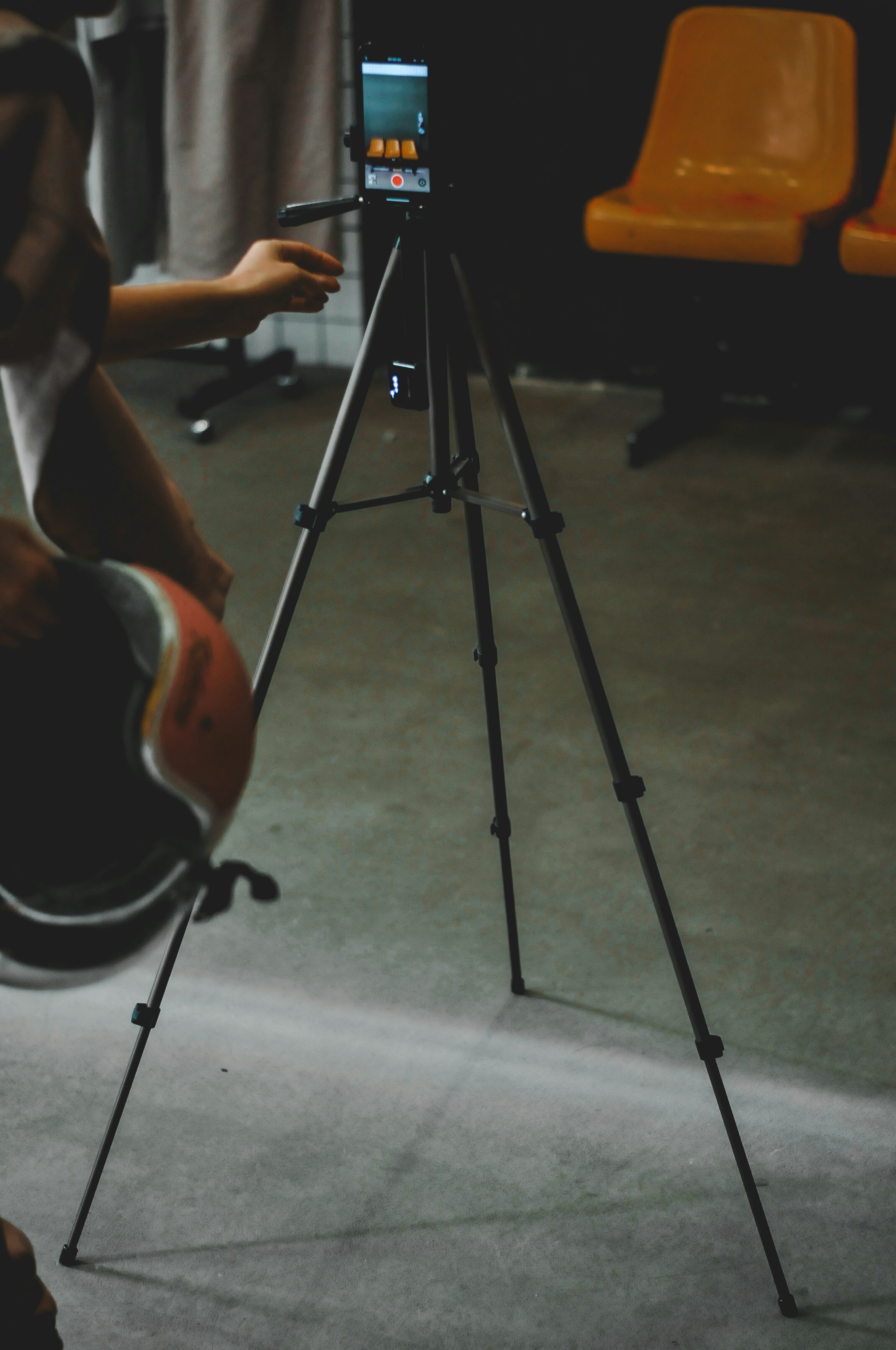 A phone records activity with a tripod.