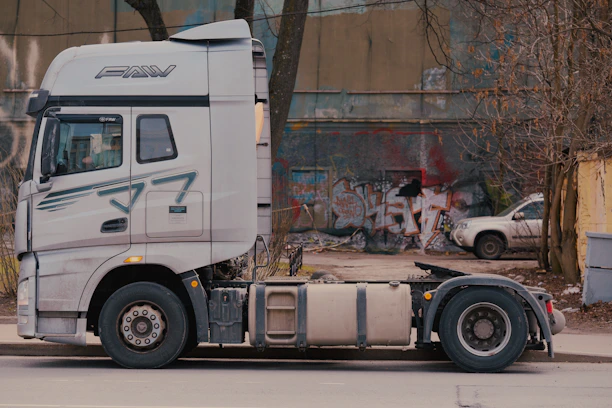 A white semi-truck parked on a street.