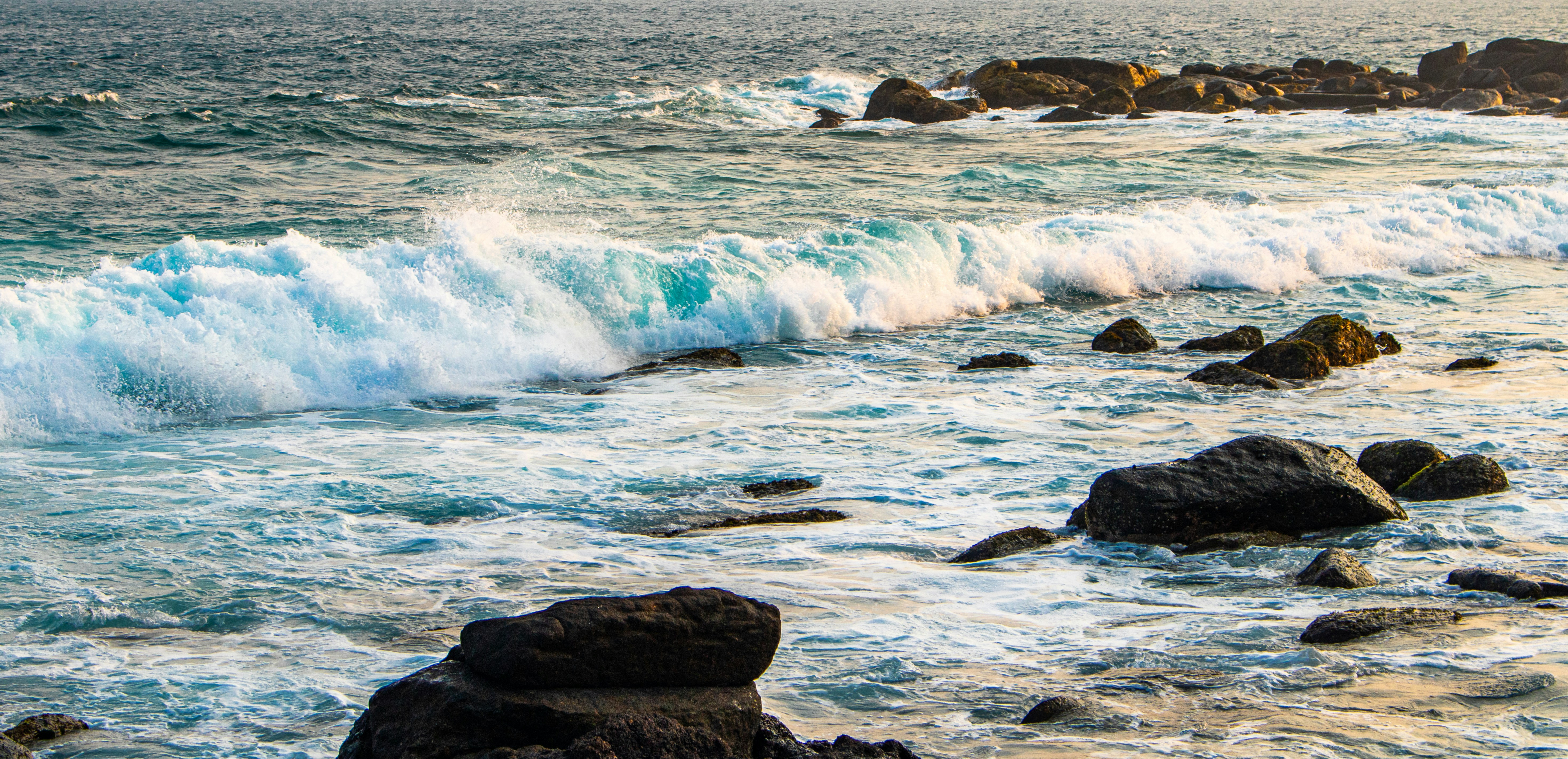 Waves crash against a rocky shoreline