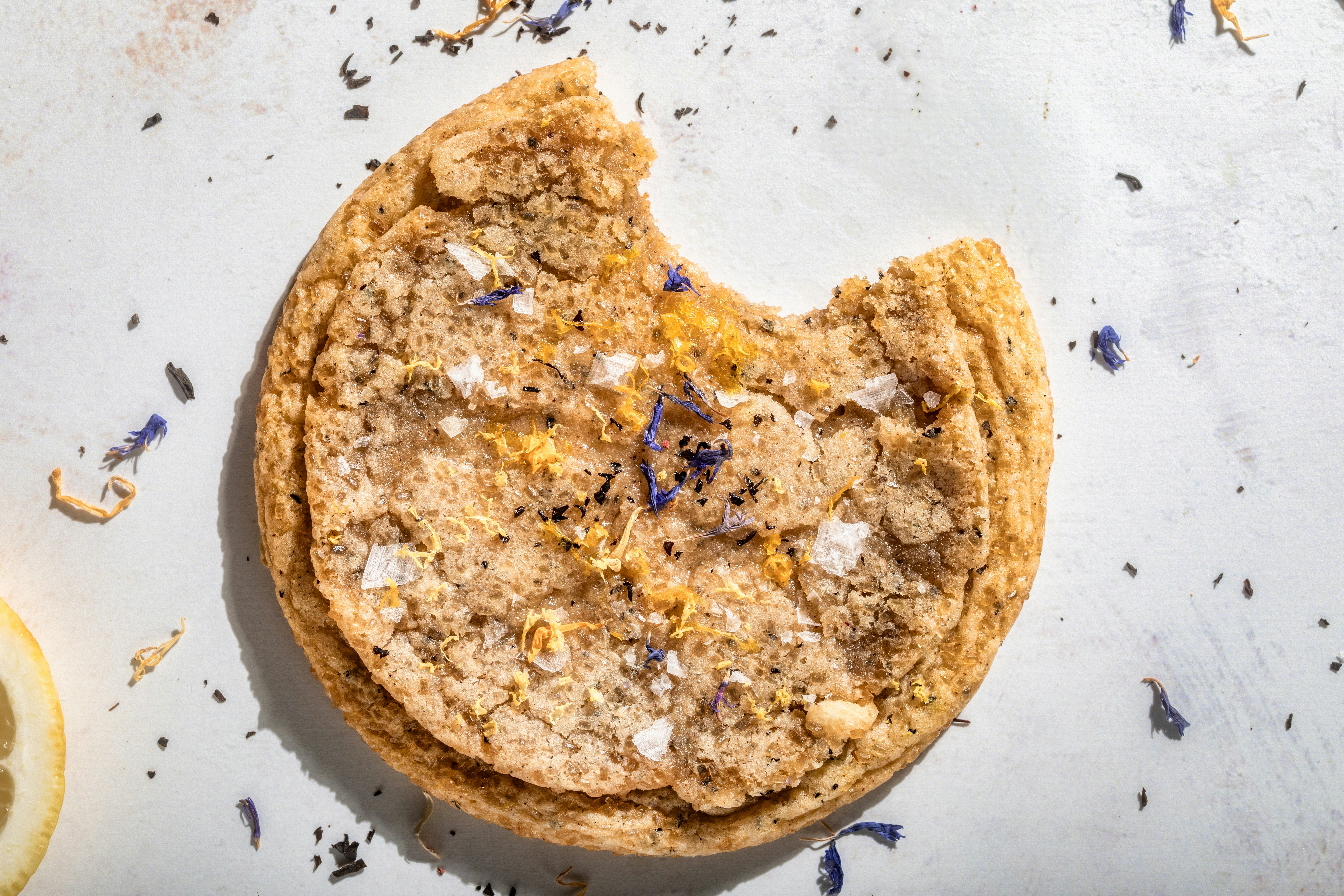 A delicious, half-eaten cookie is shown.