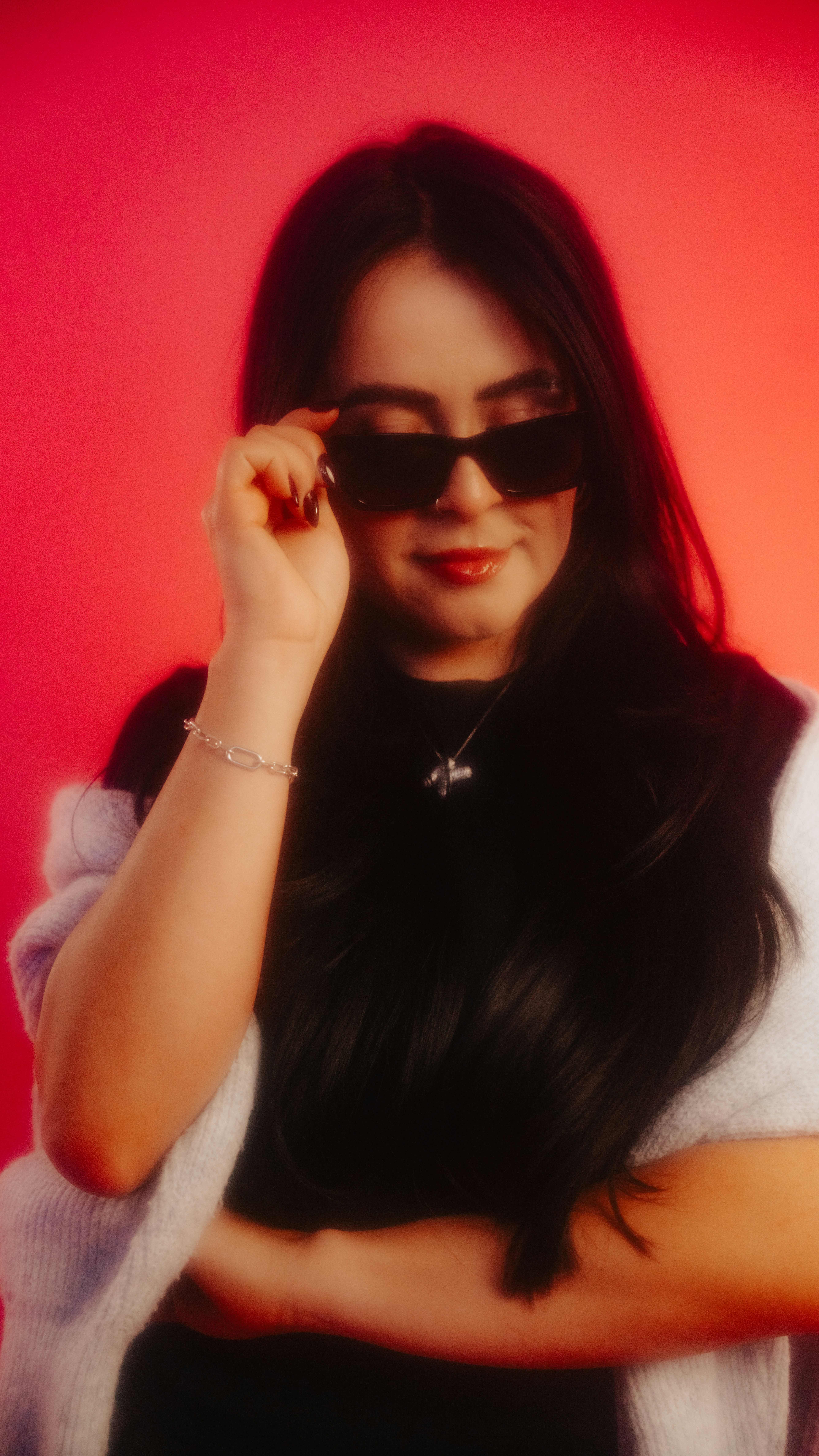 Woman in sunglasses looking down.