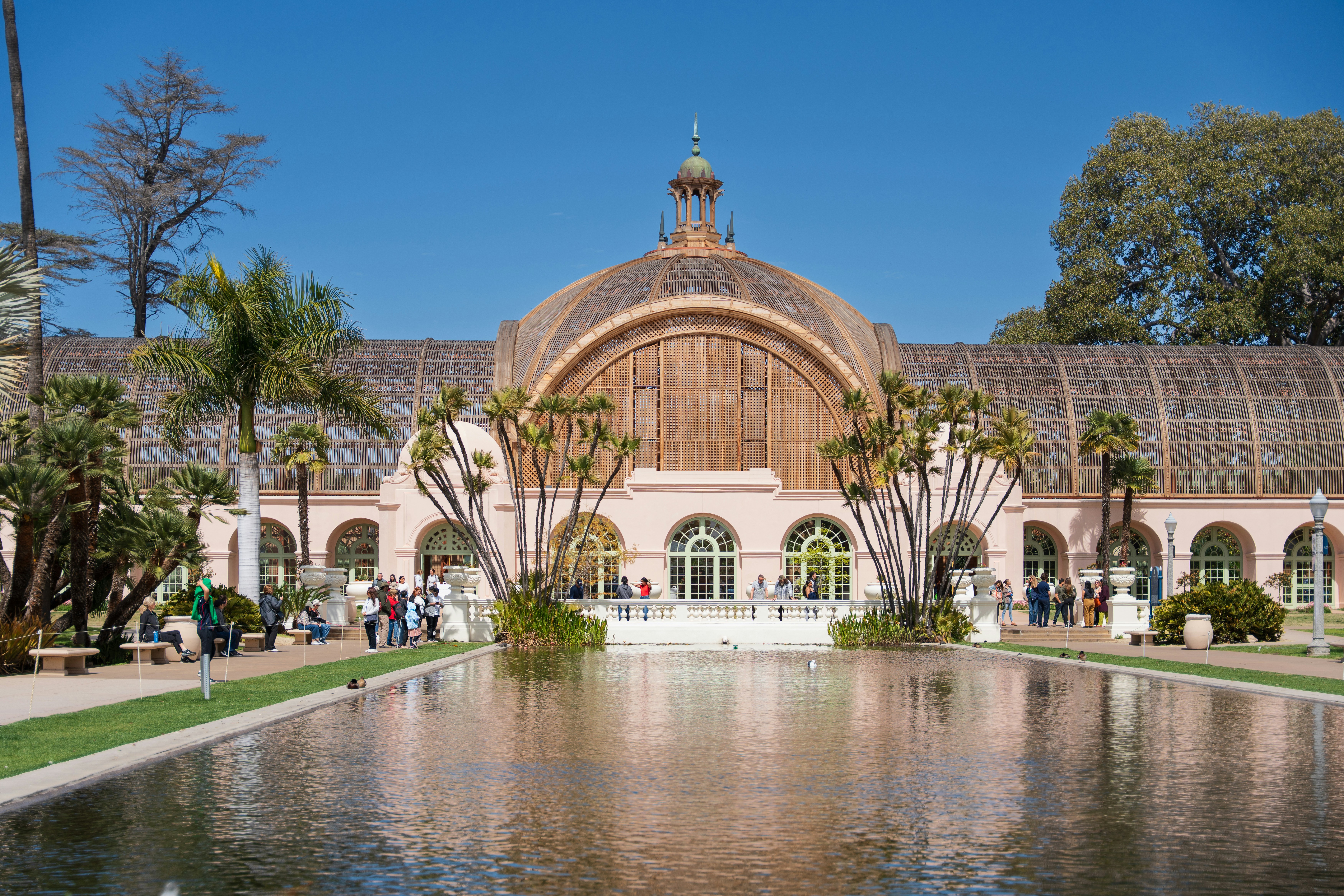 A beautiful building reflects in a calm pool.