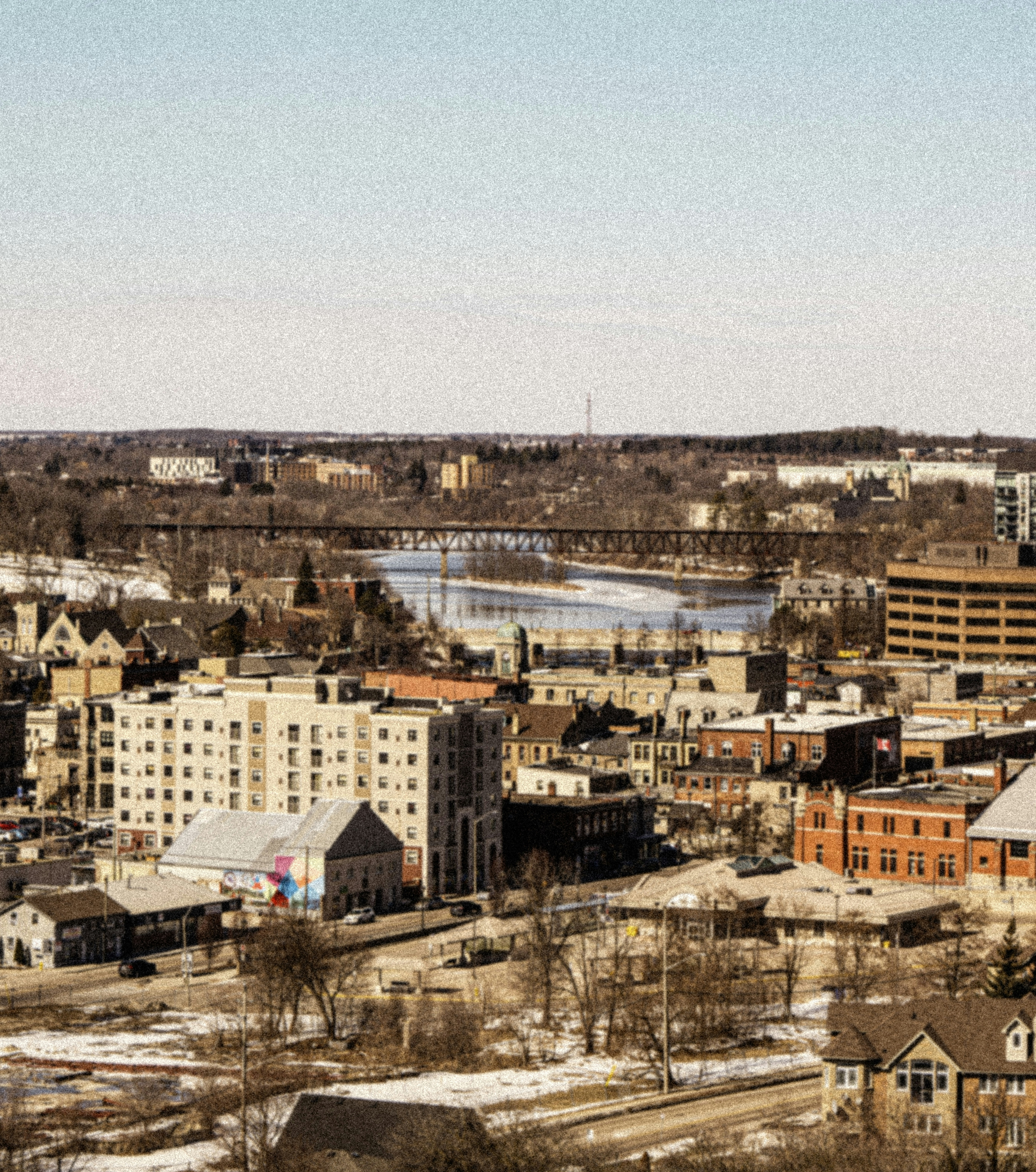 Cityscape view featuring buildings and bridge.