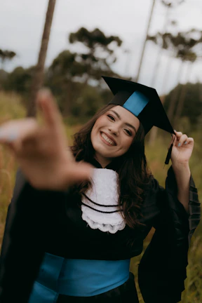 A smiling graduate poses for a photo.