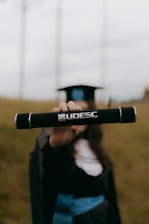 Graduation day: a diploma held up proudly.