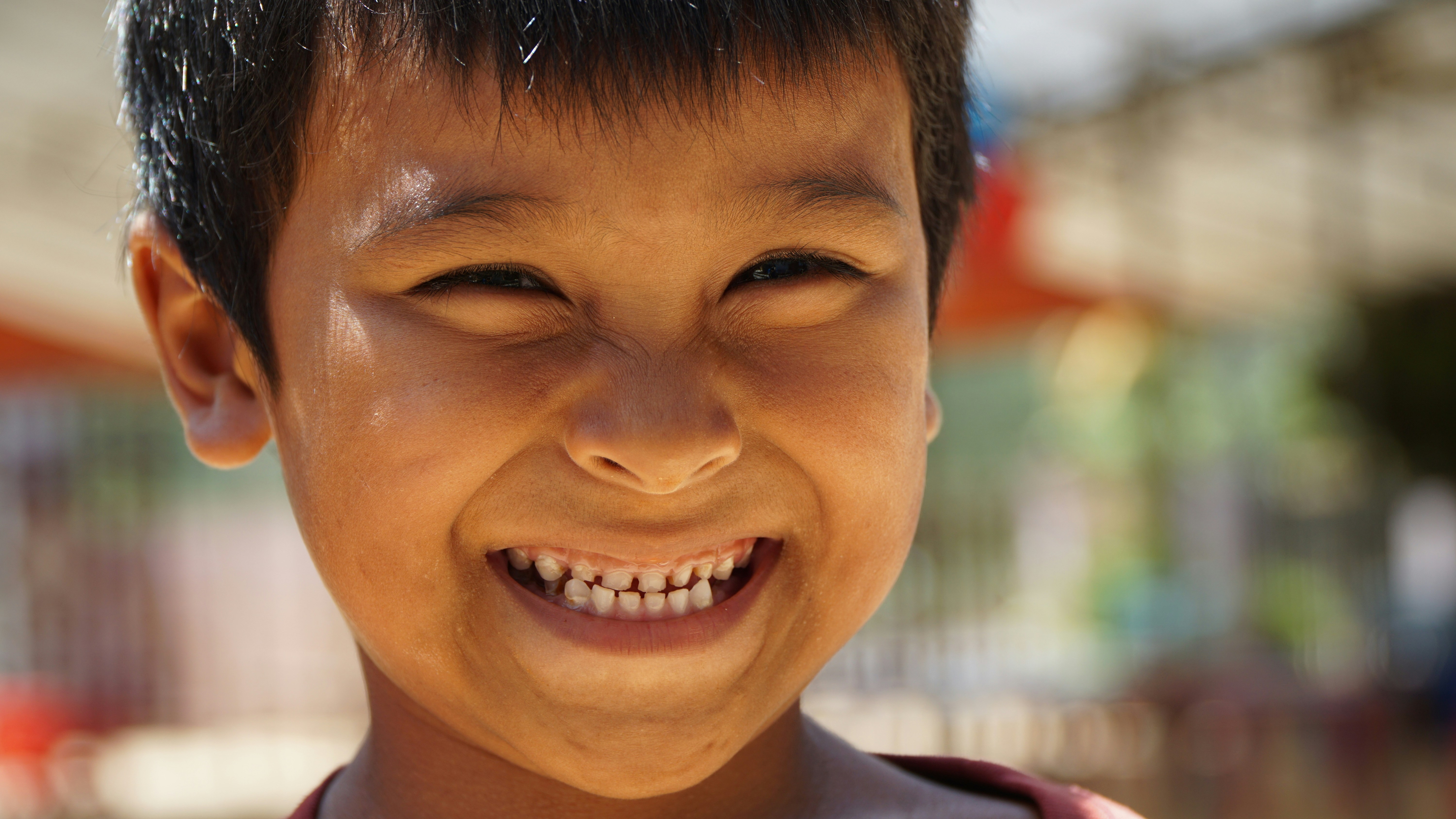child smiling showing teeth - dental sealants for kids