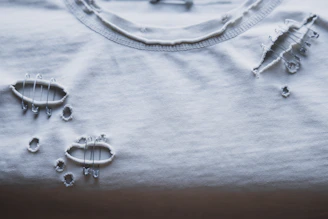 A ripped white t-shirt is shown