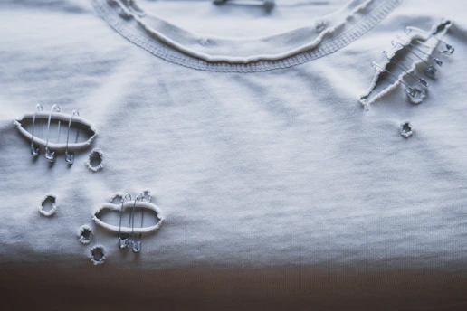 A ripped white t-shirt is shown