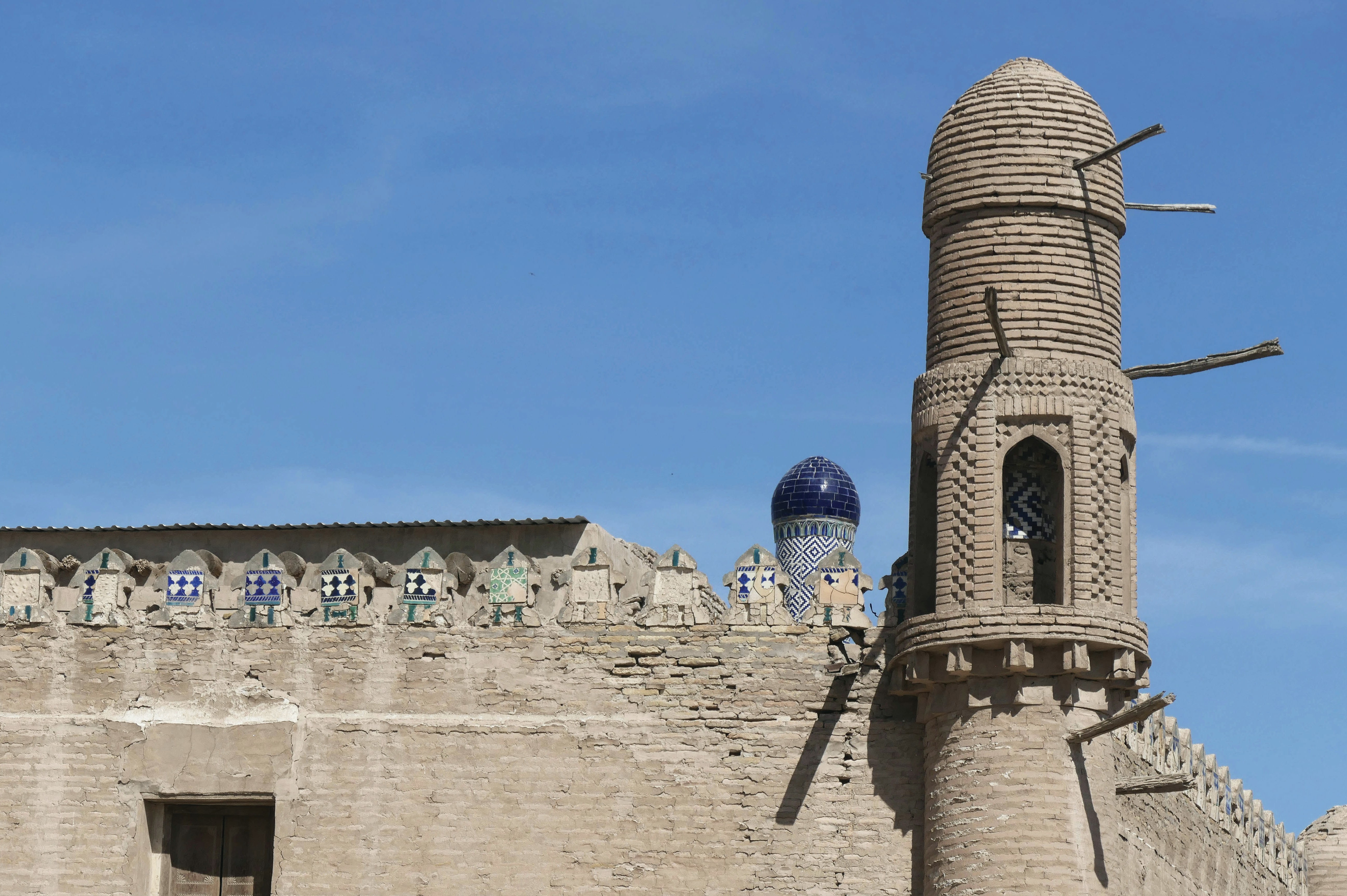 Ancient brick architecture stands tall against a blue sky.