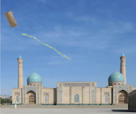A kite flies above a beautiful mosque