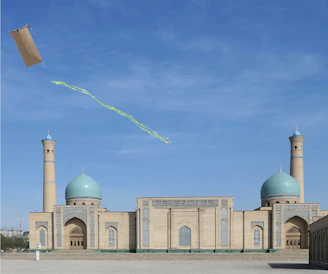 A kite flies above a beautiful mosque