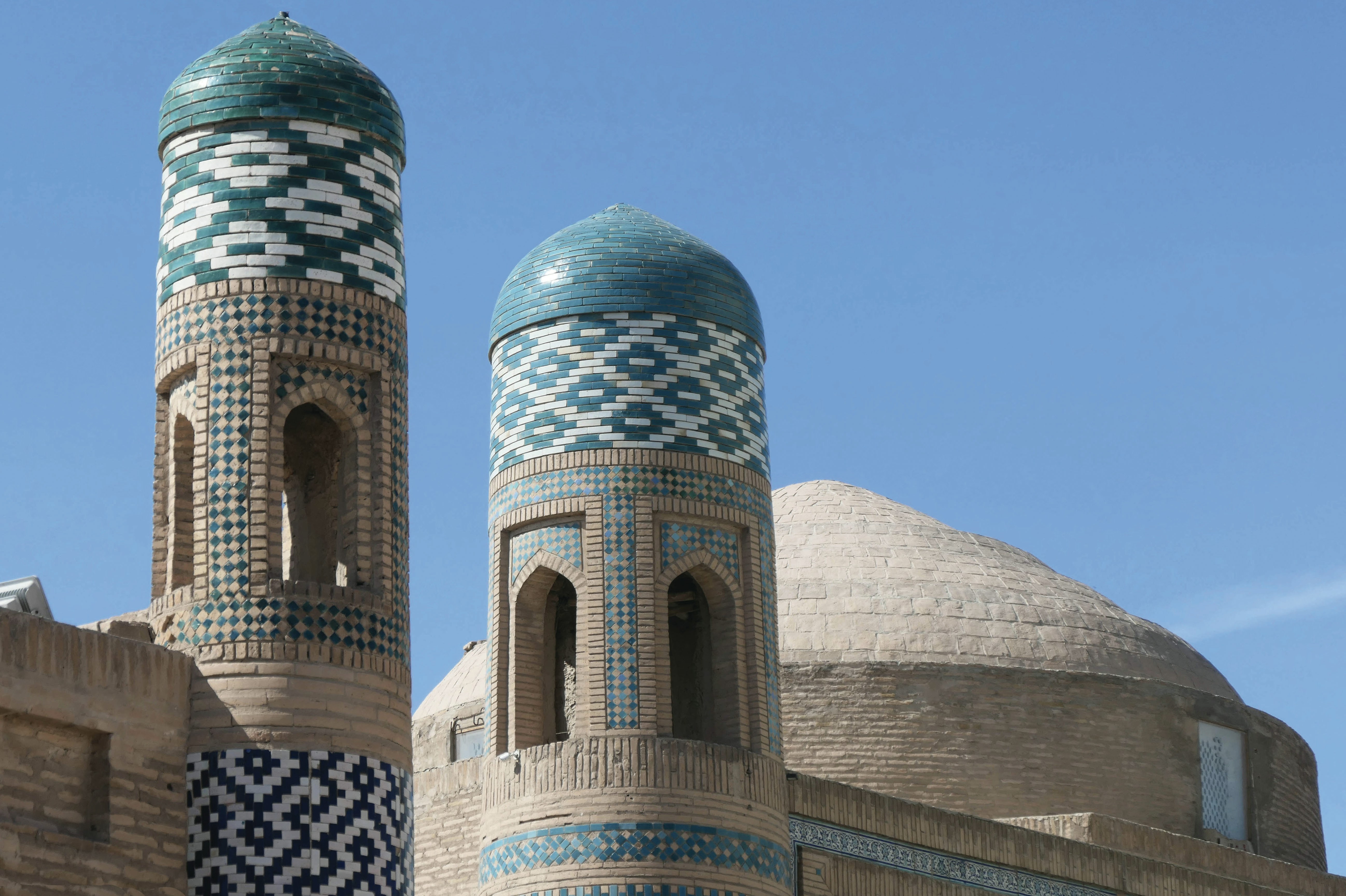 Turquoise-domed towers of an ancient building.