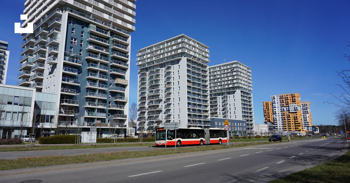 Modern high-rise buildings with a bus on a road. photo – Free Bus Image ...