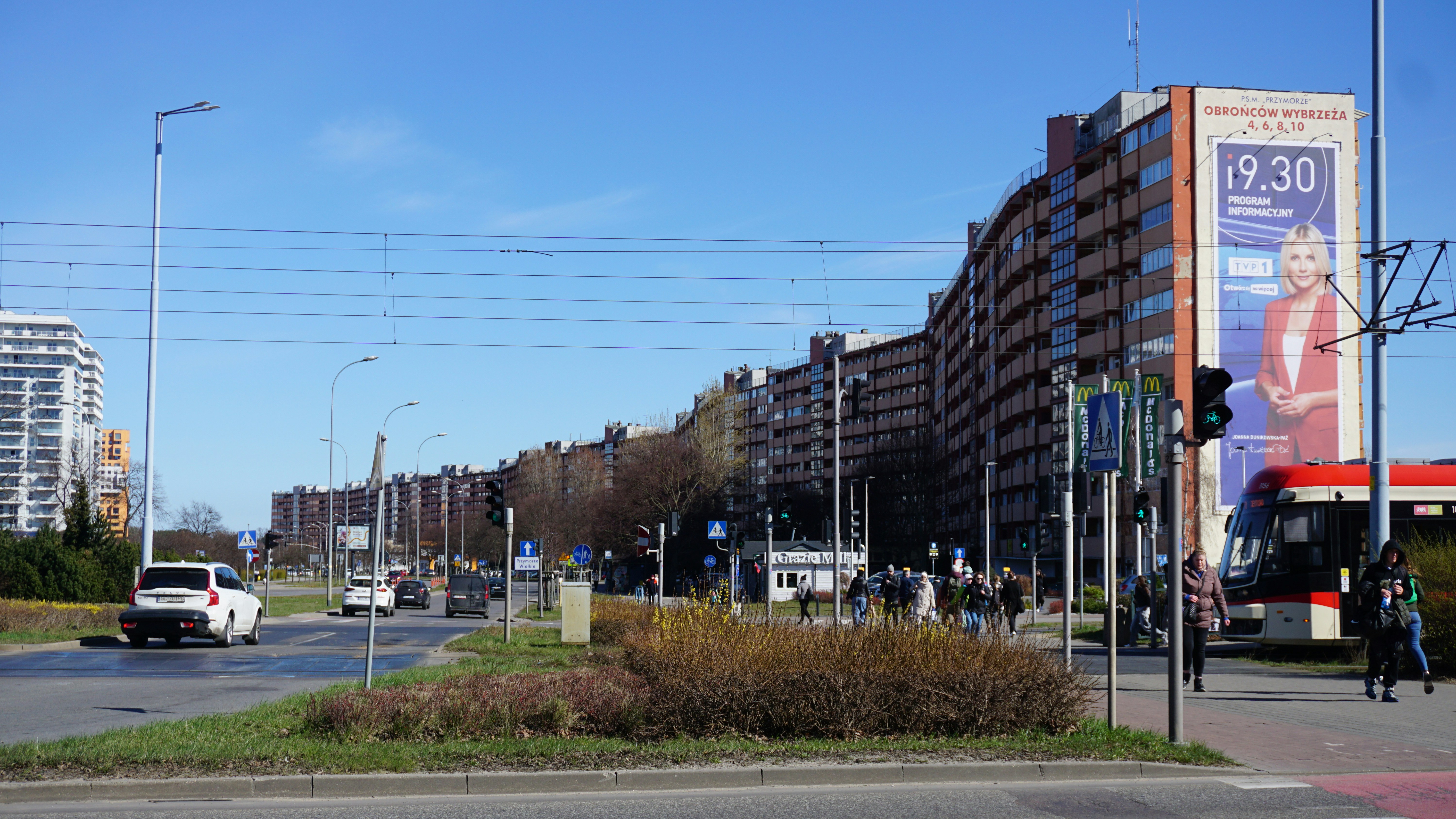 Urban street view with buildings and a bus.