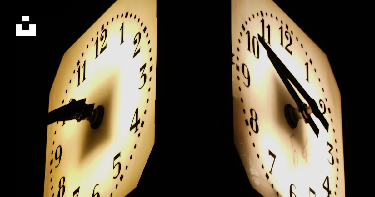 Two illuminated clocks show different times. photo – Free Clock Image ...