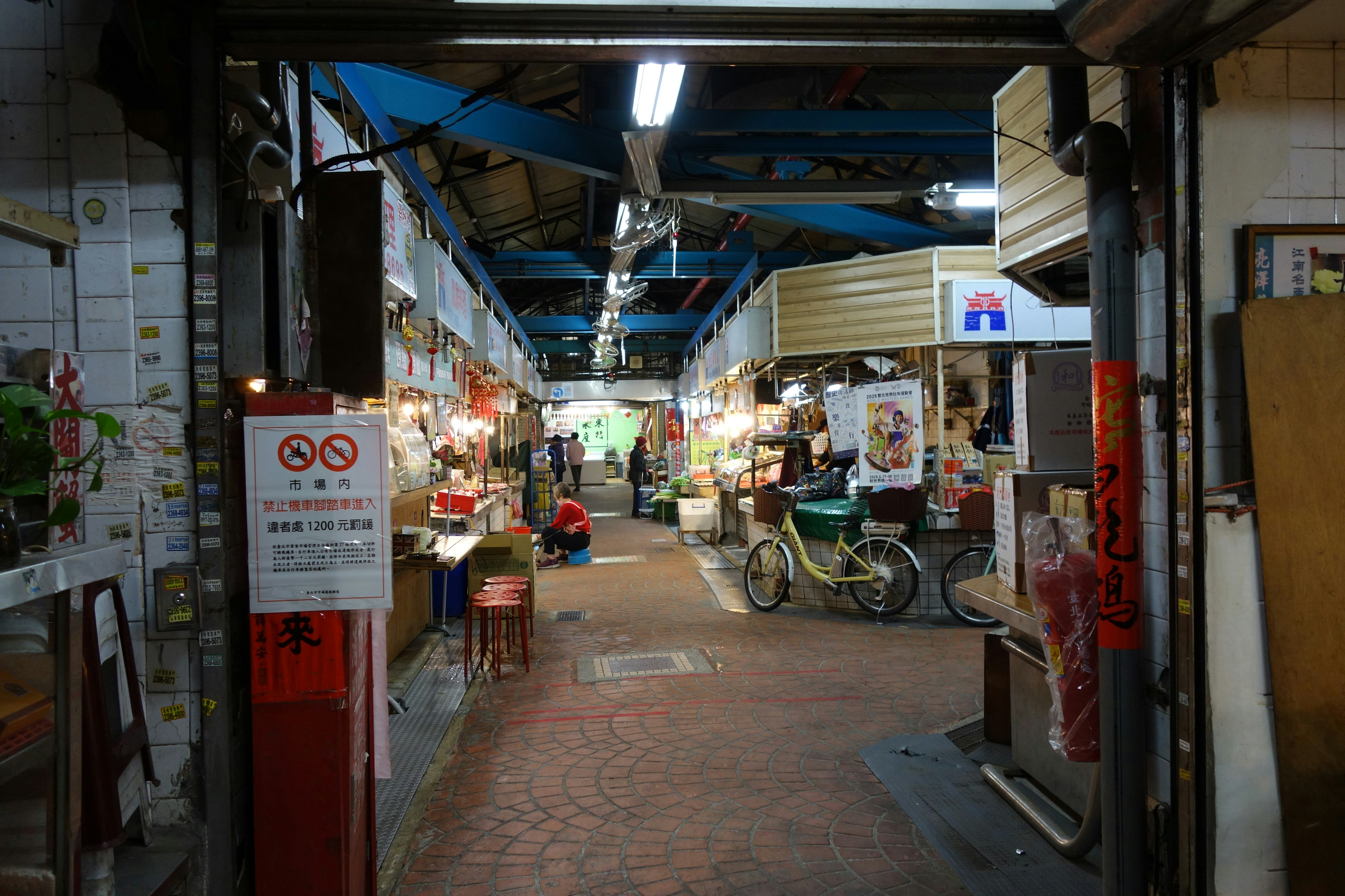 An open-air market is seen through an entrance.