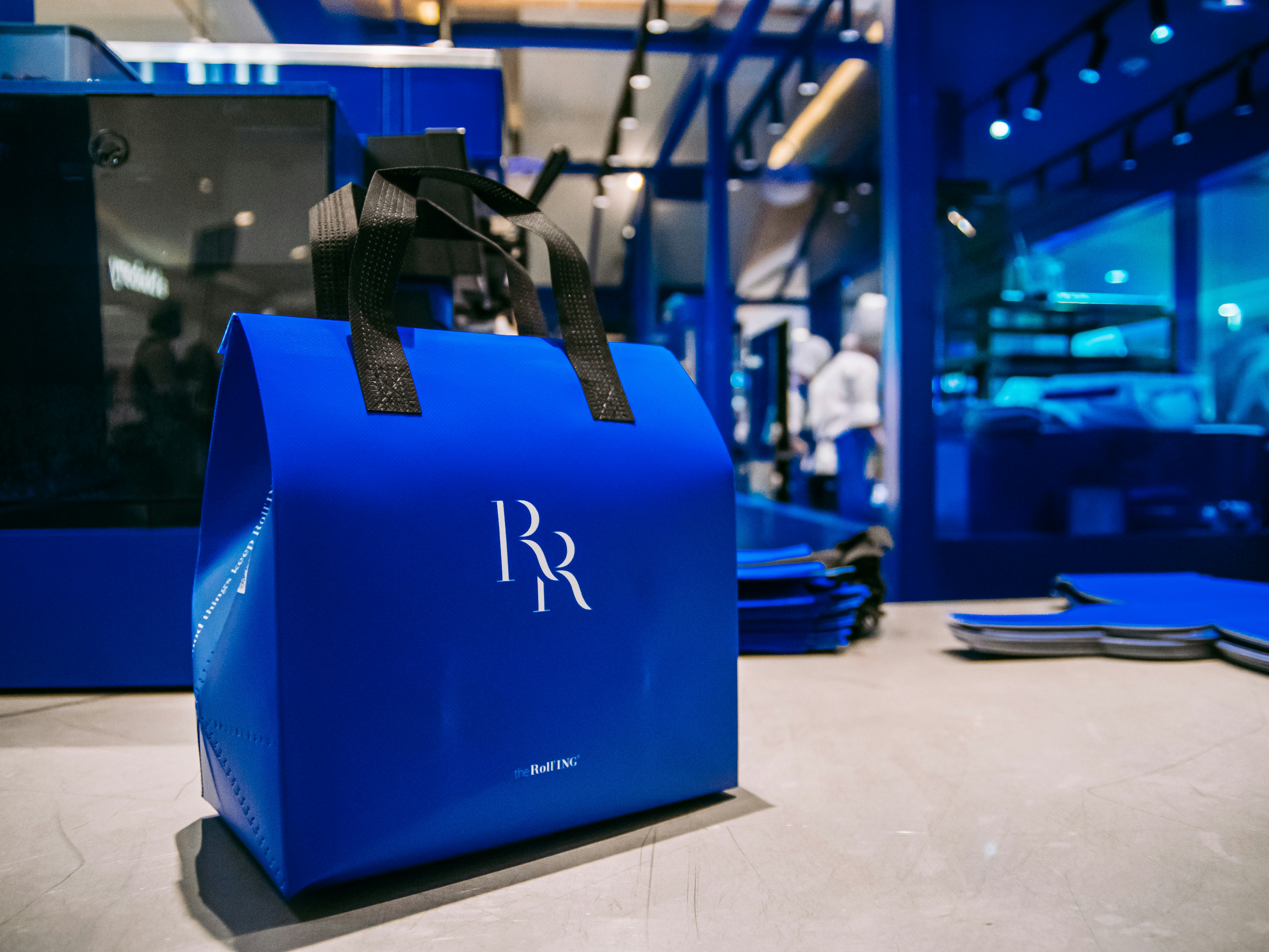 A royal blue tote bag in a store.