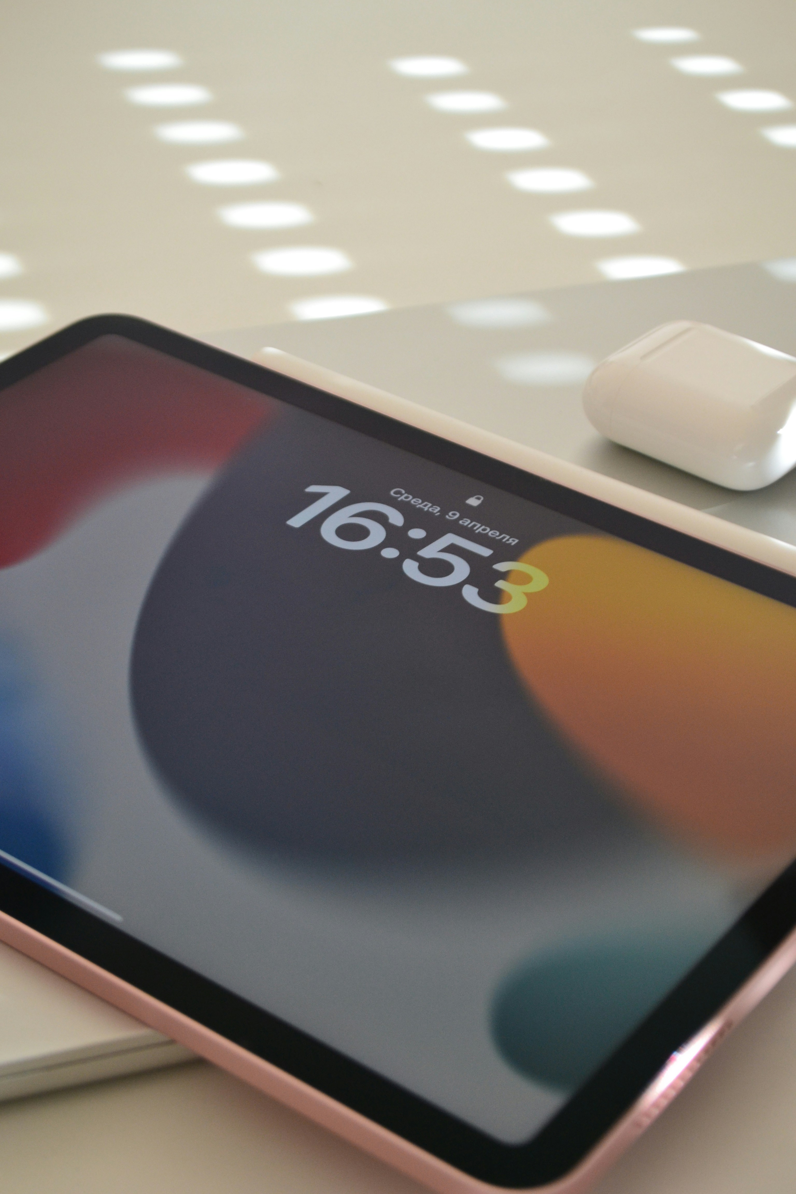 An ipad, airpods, and apple pencil are displayed.