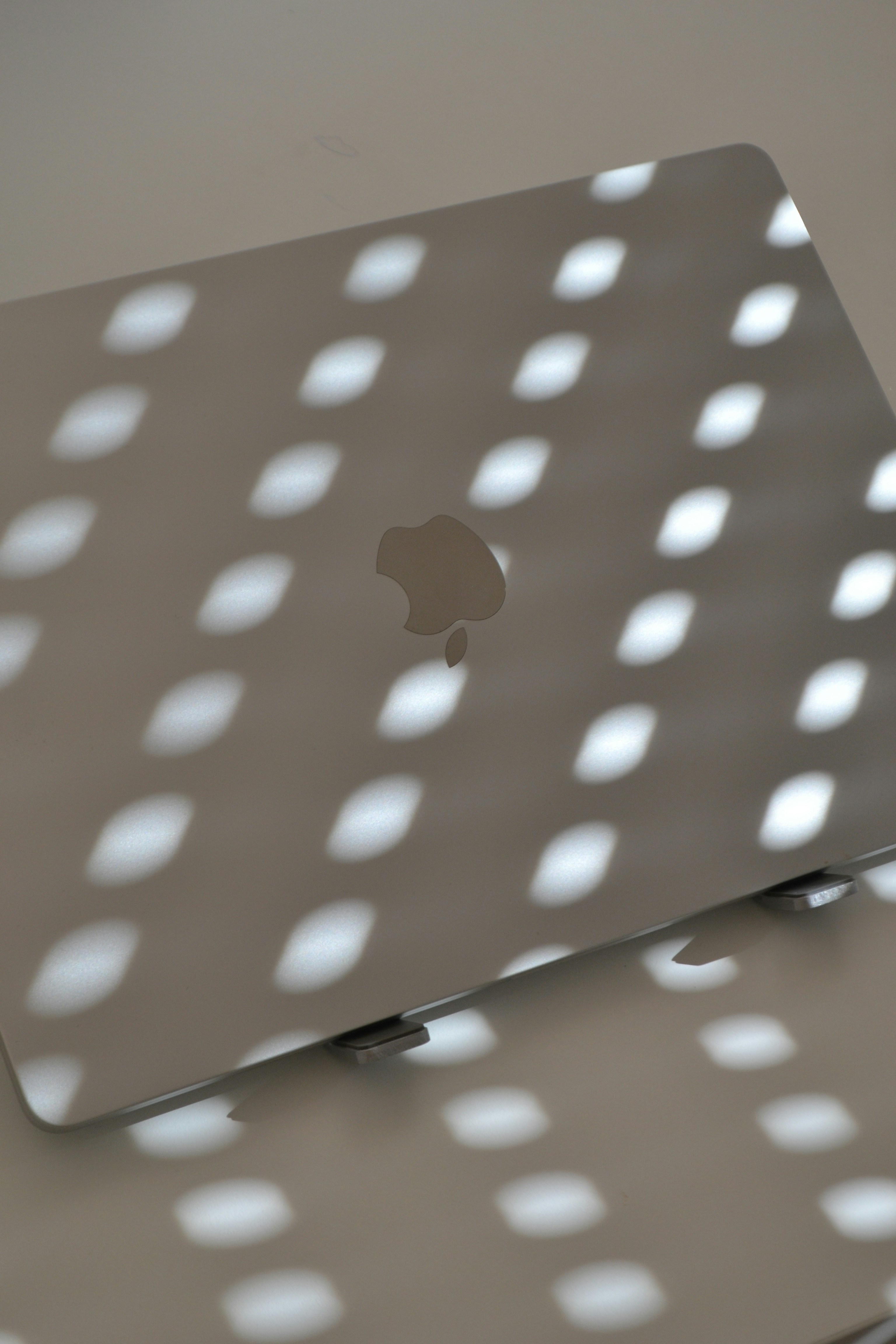 Laptop under light, creating shadows.