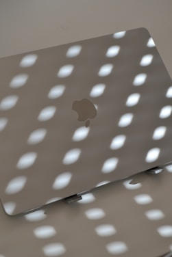 Laptop under light, creating shadows.