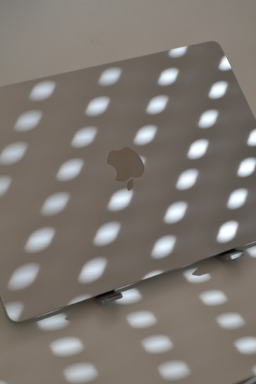 Laptop under light, creating shadows.