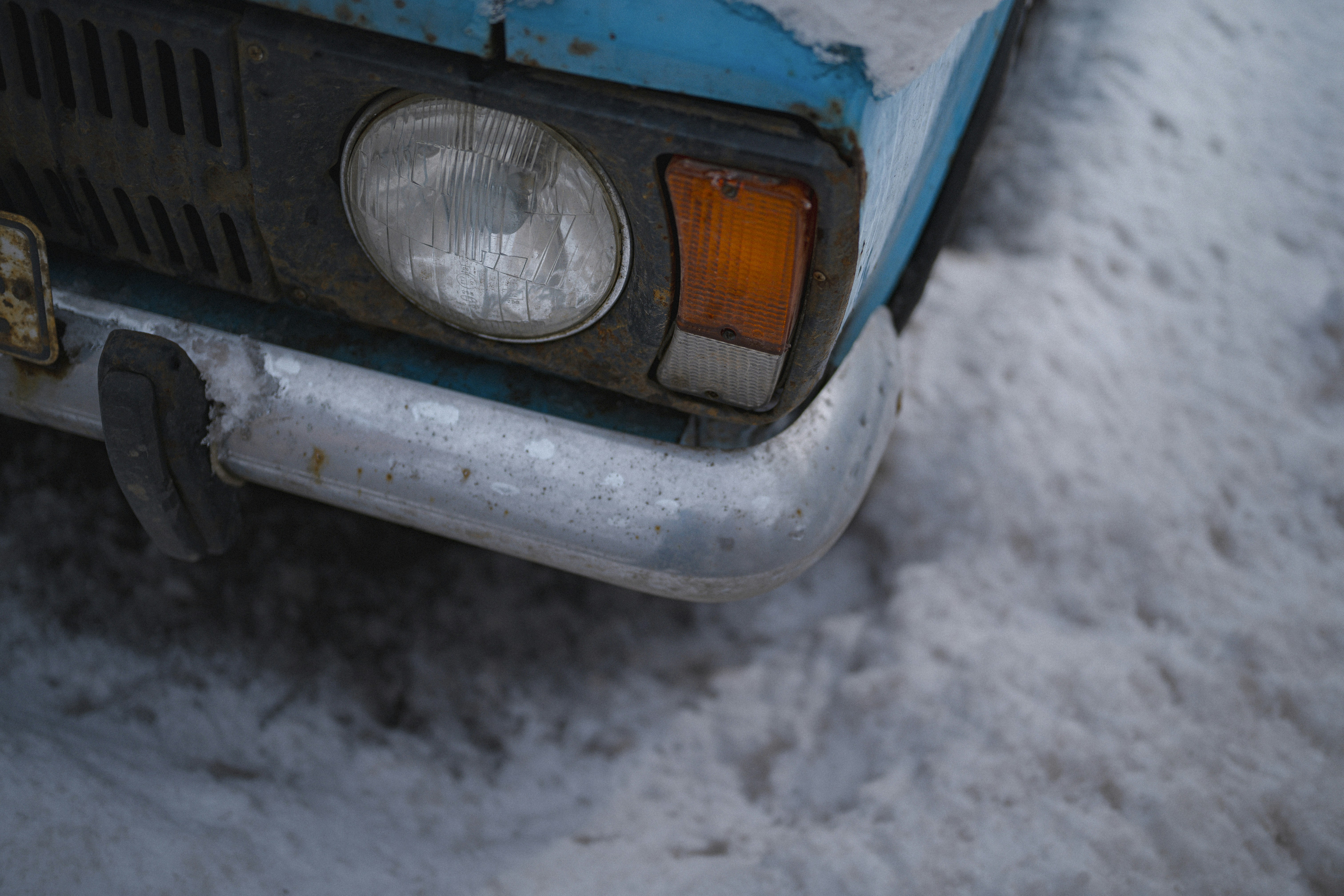 A close-up shows the front of an old car.