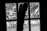 Through a window, we see a restaurant patio.