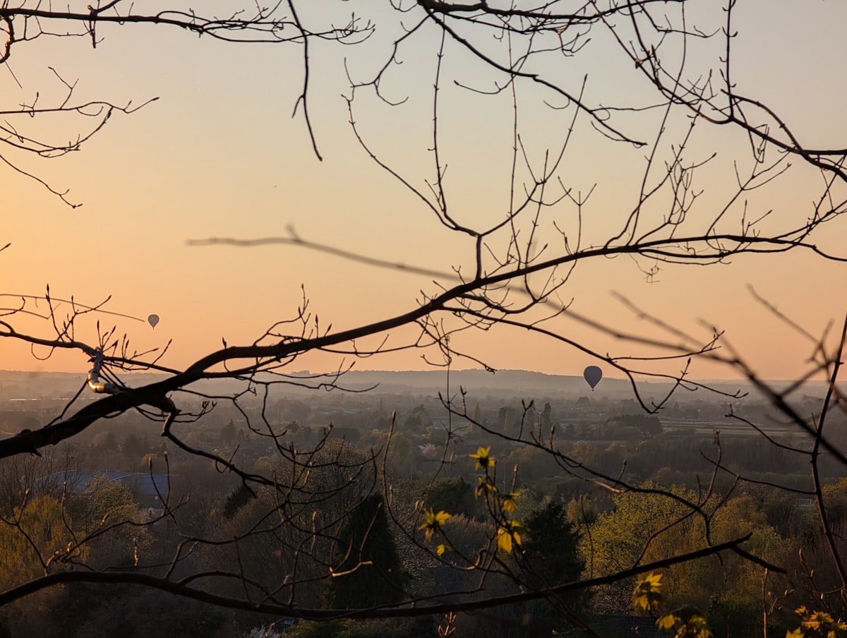 Sunset over the Chilterns countryside in Buckinghamshire with hot air balloons