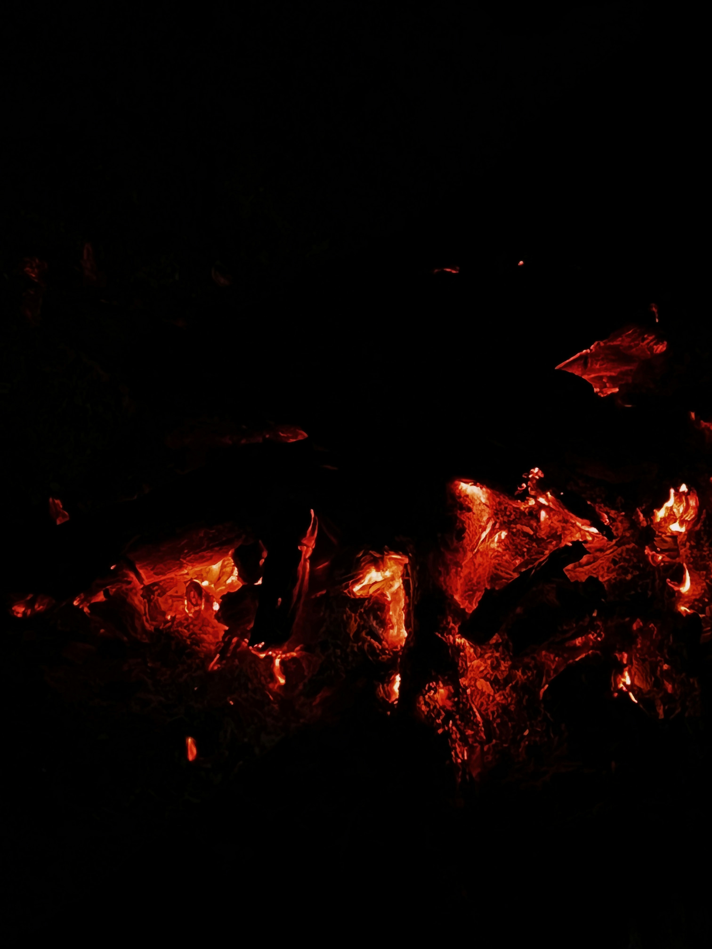 Glowing embers illuminate the surrounding darkness.