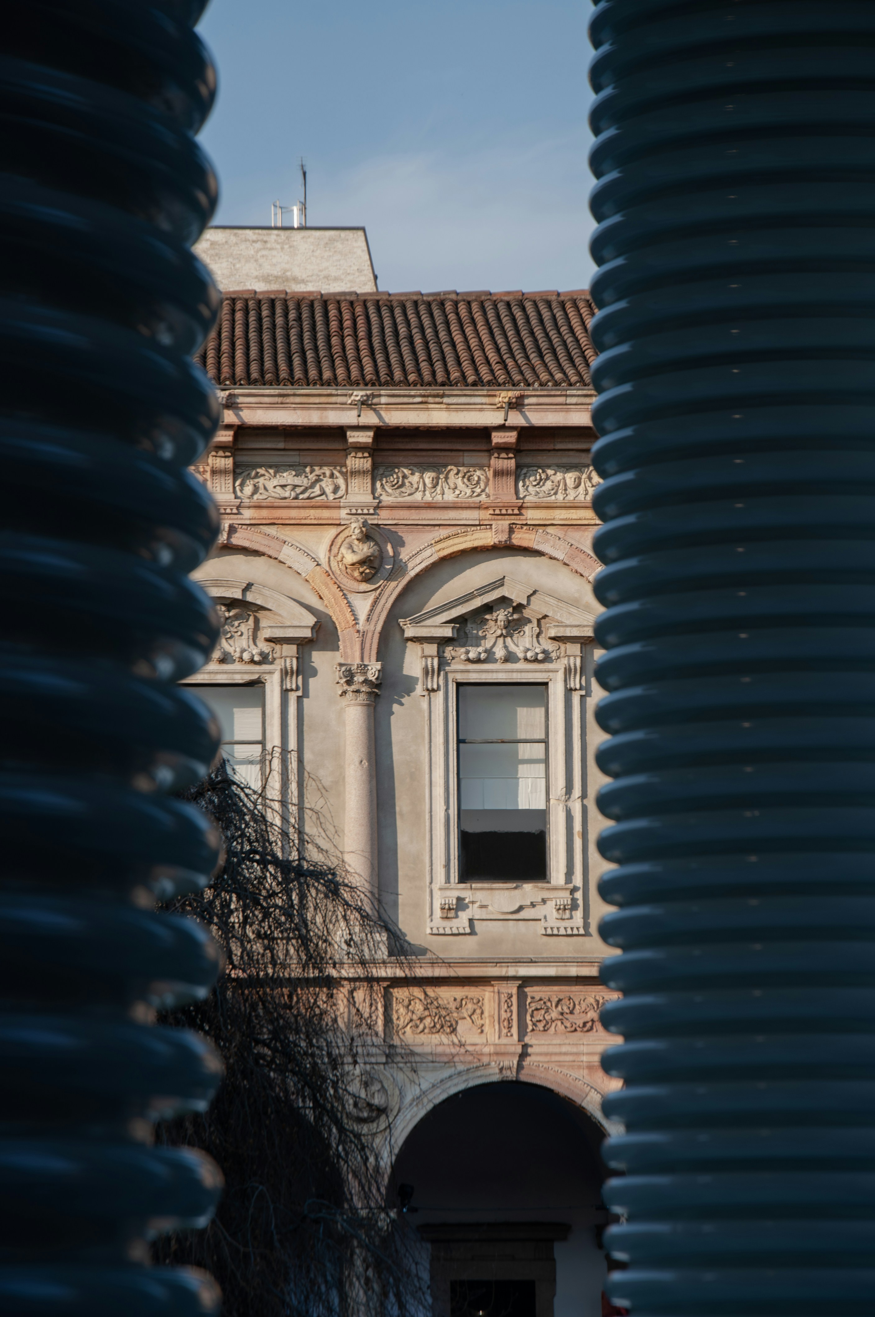View of a classical building through a structure.