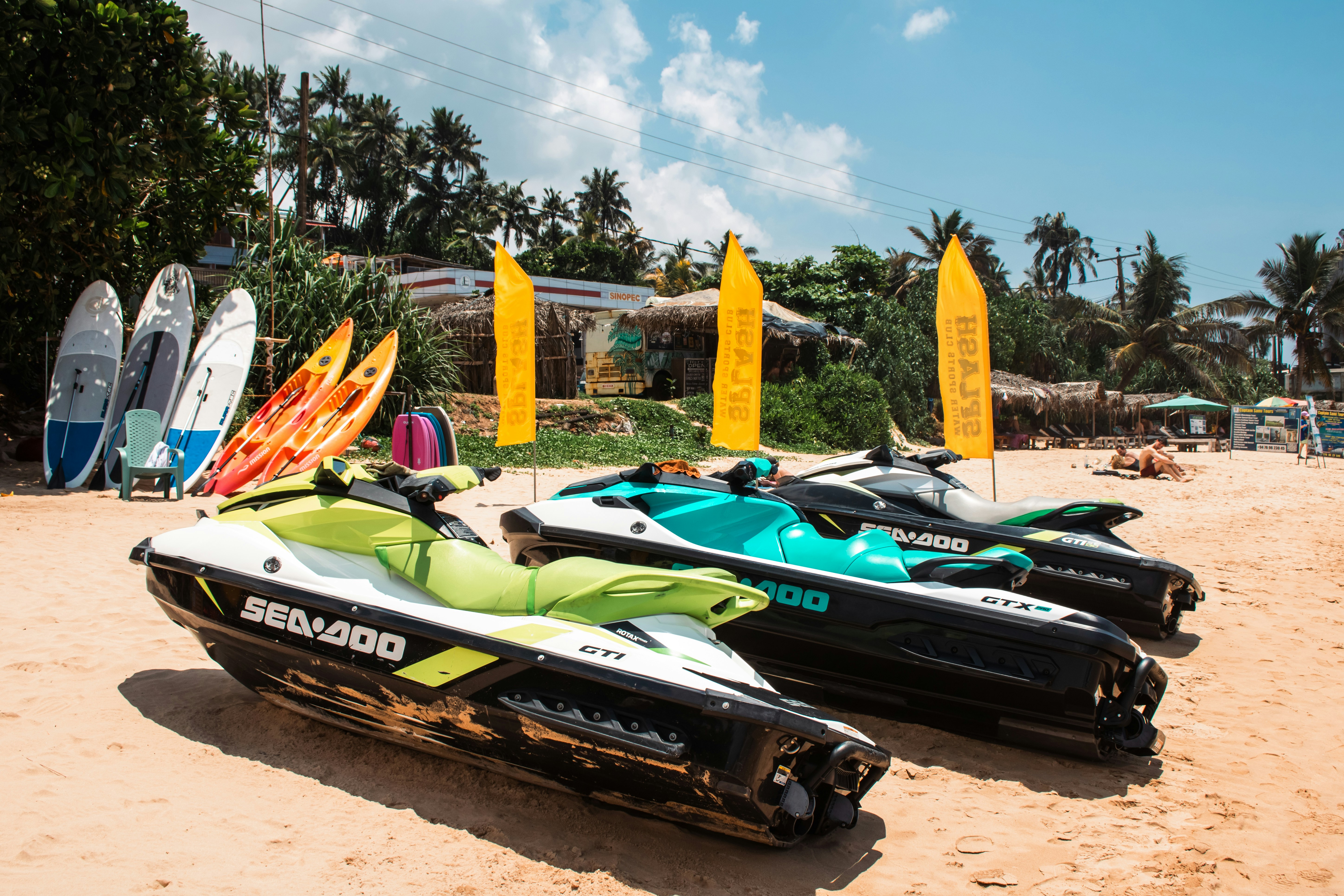 Jet skis and watersports equipment on the beach.