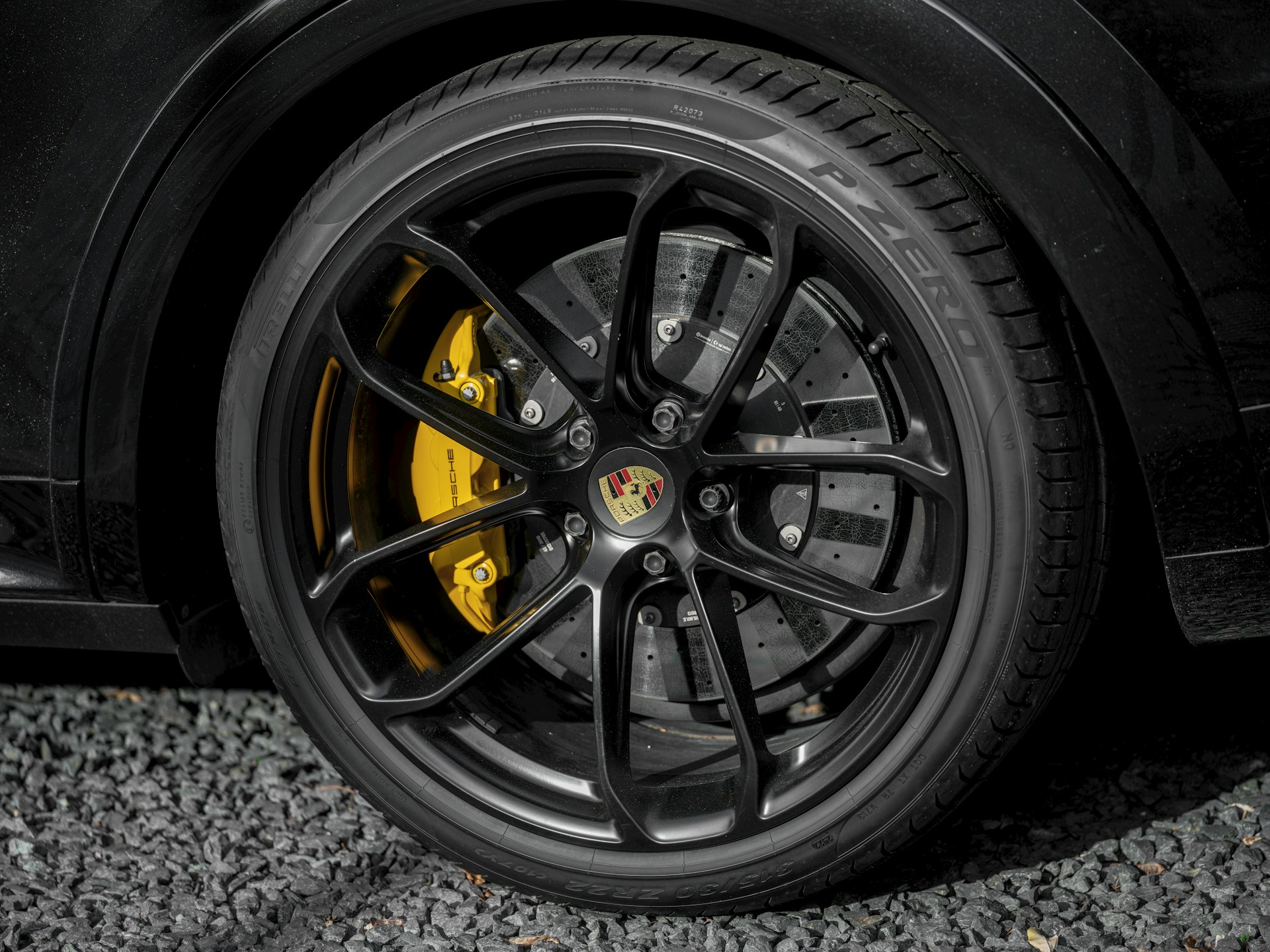 A close-up of a porsche car wheel.