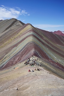 Rainbow mountain in peru with visitors.
