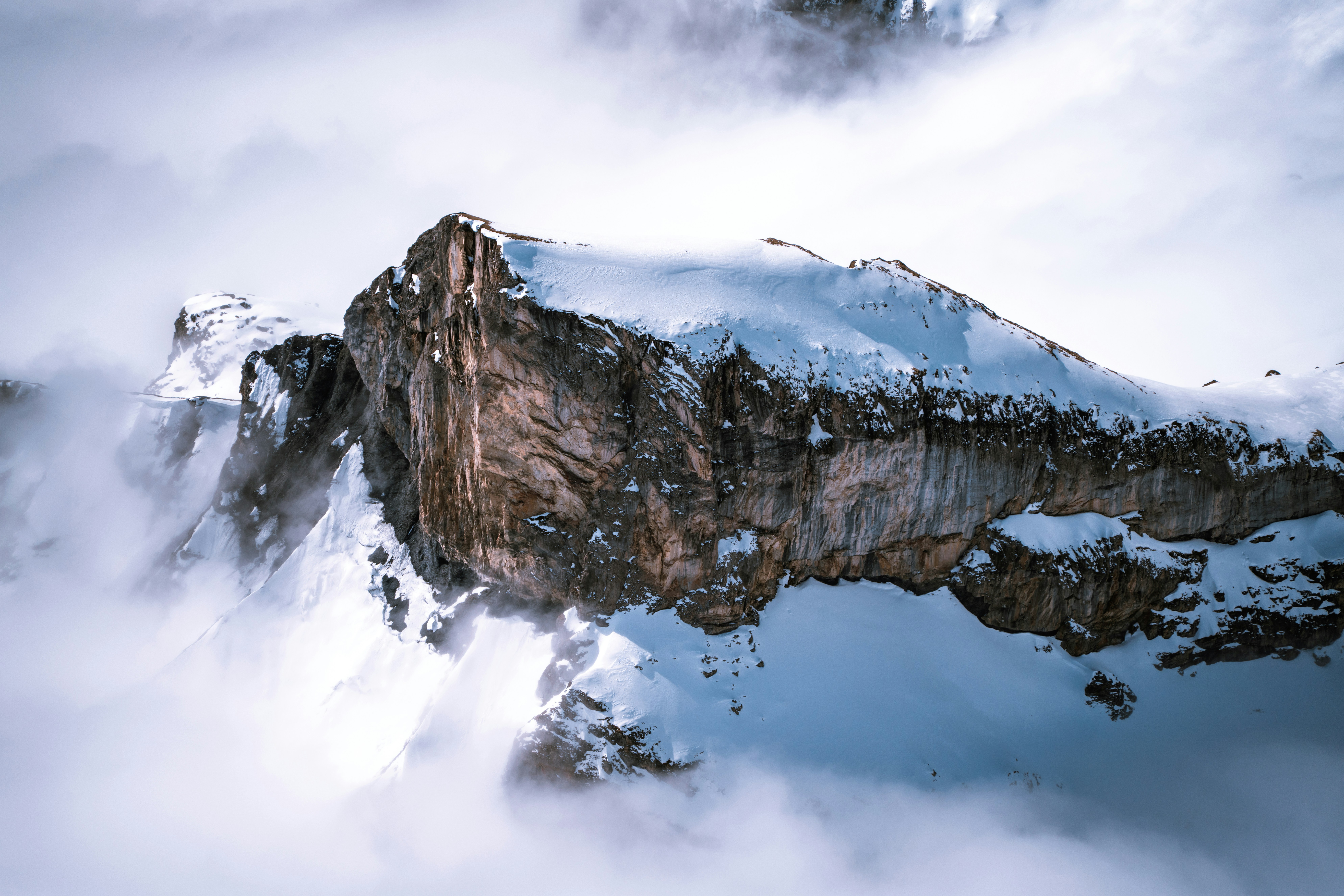 A snowy mountain peak is visible through the clouds.